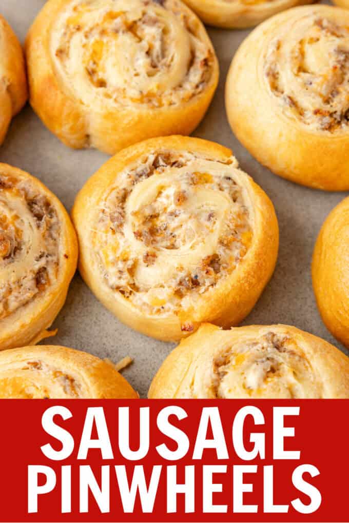 A close up of sausage pinwheels on a cookie sheet.