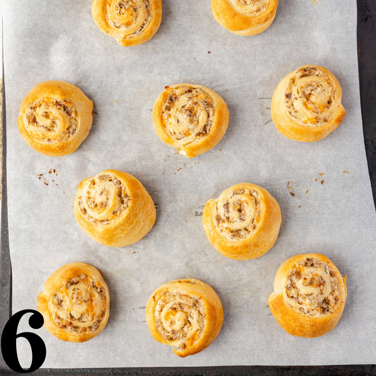 Sausage pinwheels on a white plate.