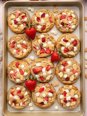 A cookie sheet full of strawberry cheesecake cookies.