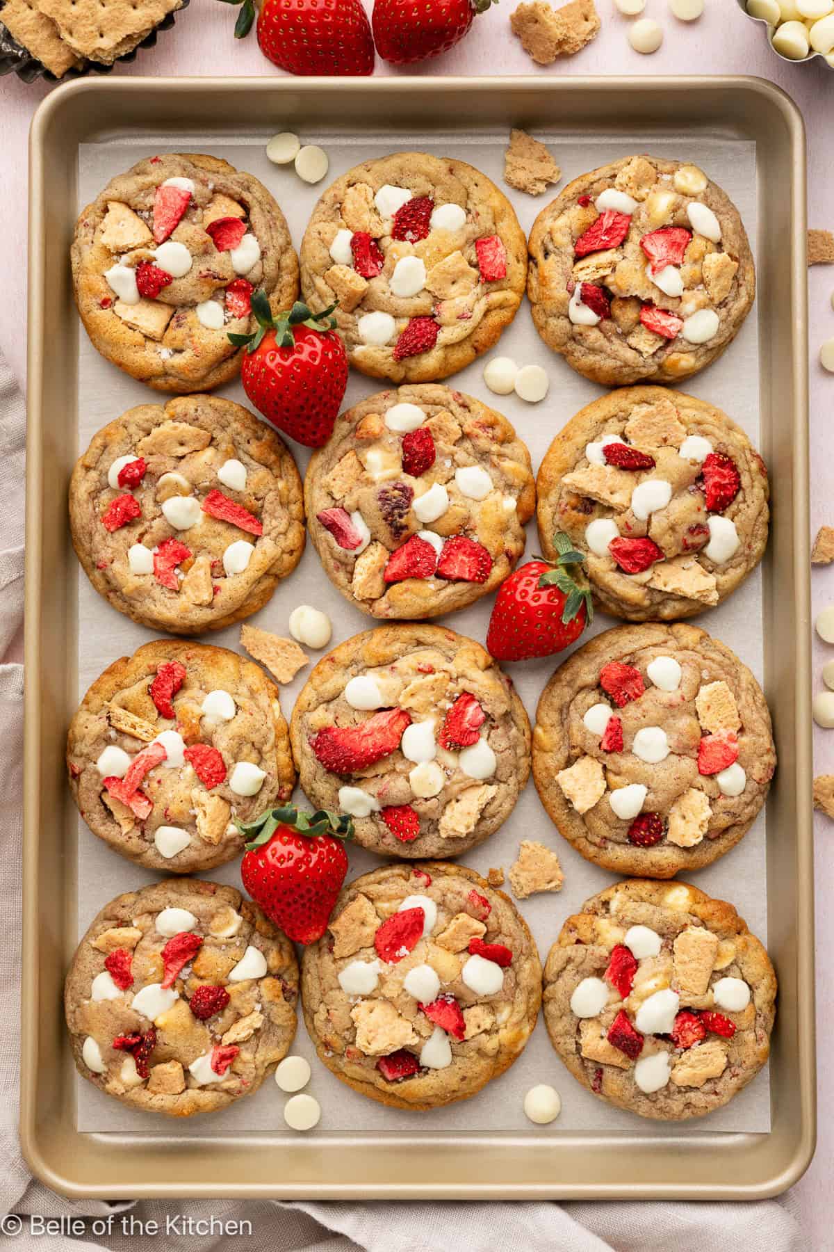 A cookie sheet full of strawberry cheesecake cookies.
