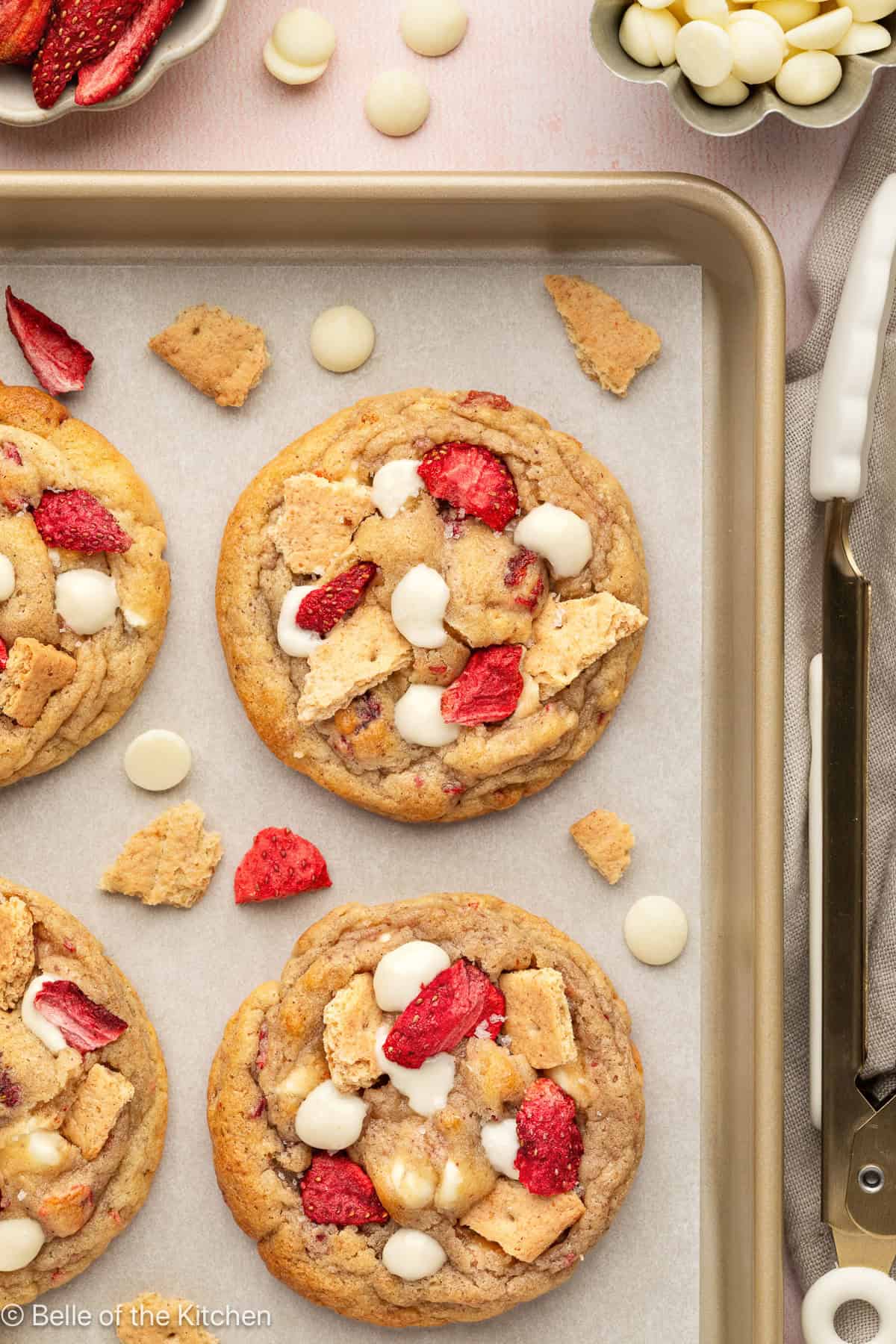 A cookie sheet full of strawberry cheesecake cookies.