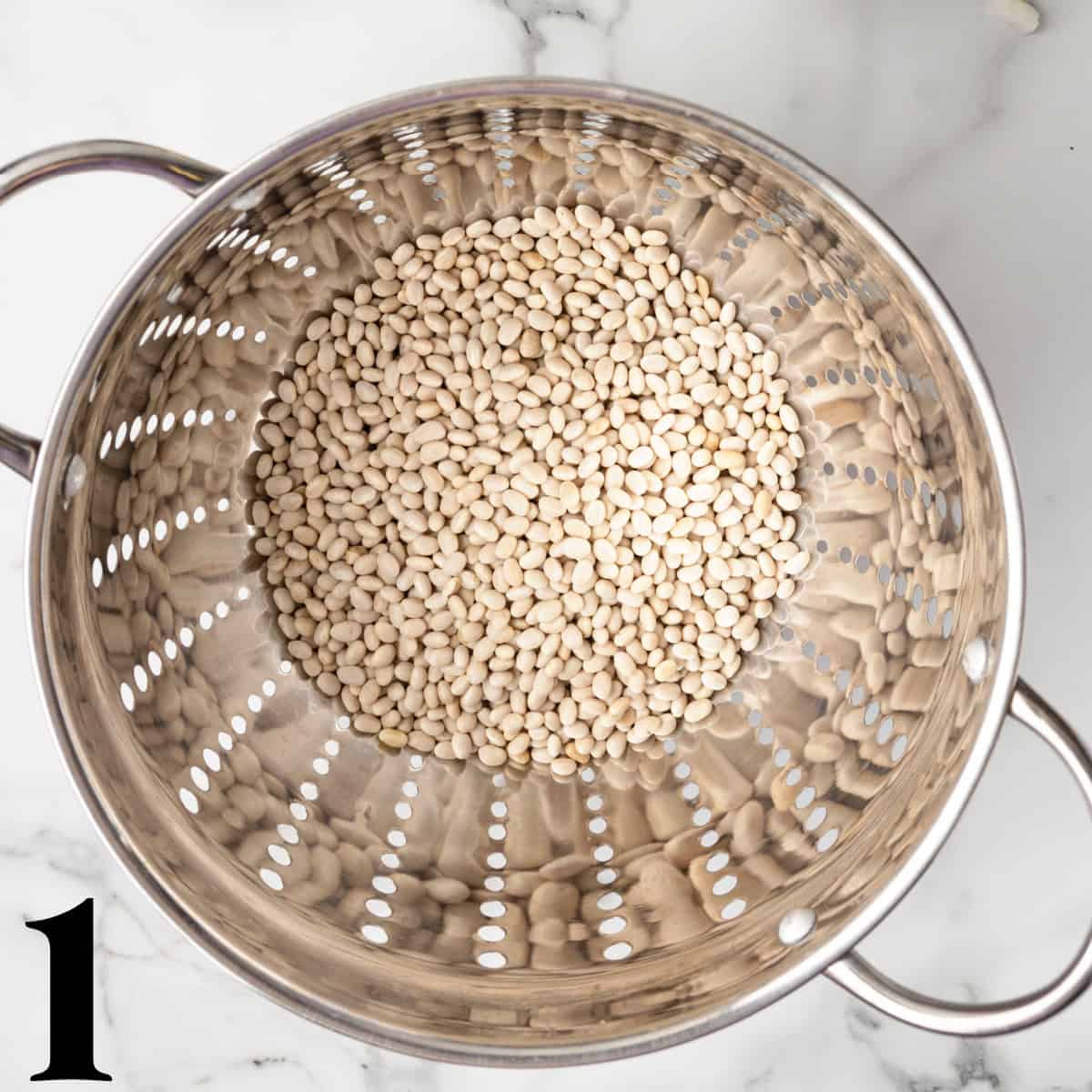 A colander full of dried beans.