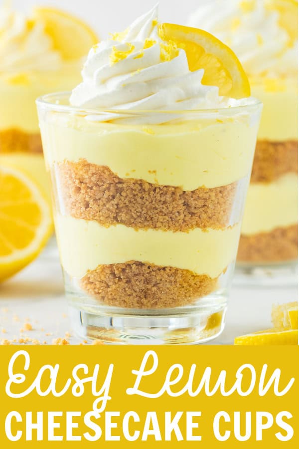 A cup of lemon cheesecake with whipped cream and a lemon on top.