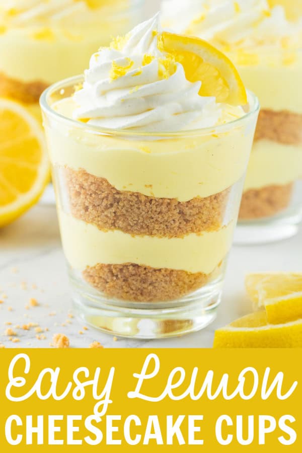 A cup of lemon cheesecake with whipped cream and a lemon on top.