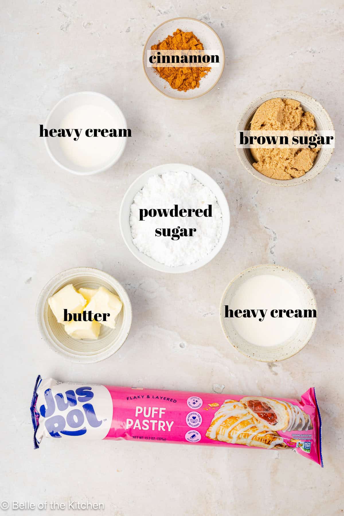 Ingredients for cinnamon rolls on a white counter top.