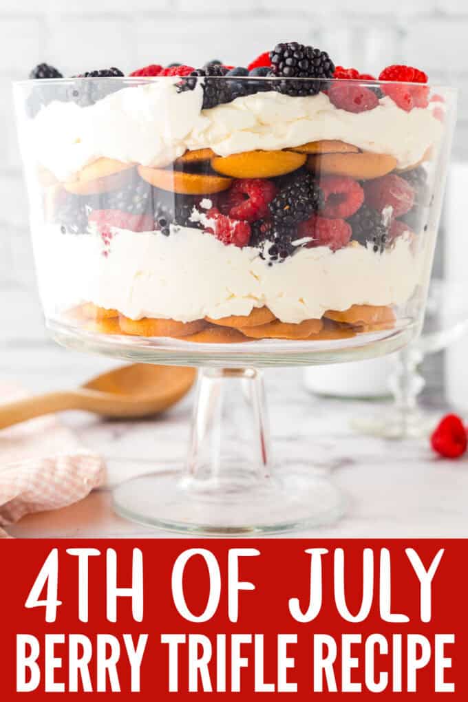 A trifle bowl full of vanilla wafers and mixd berries.