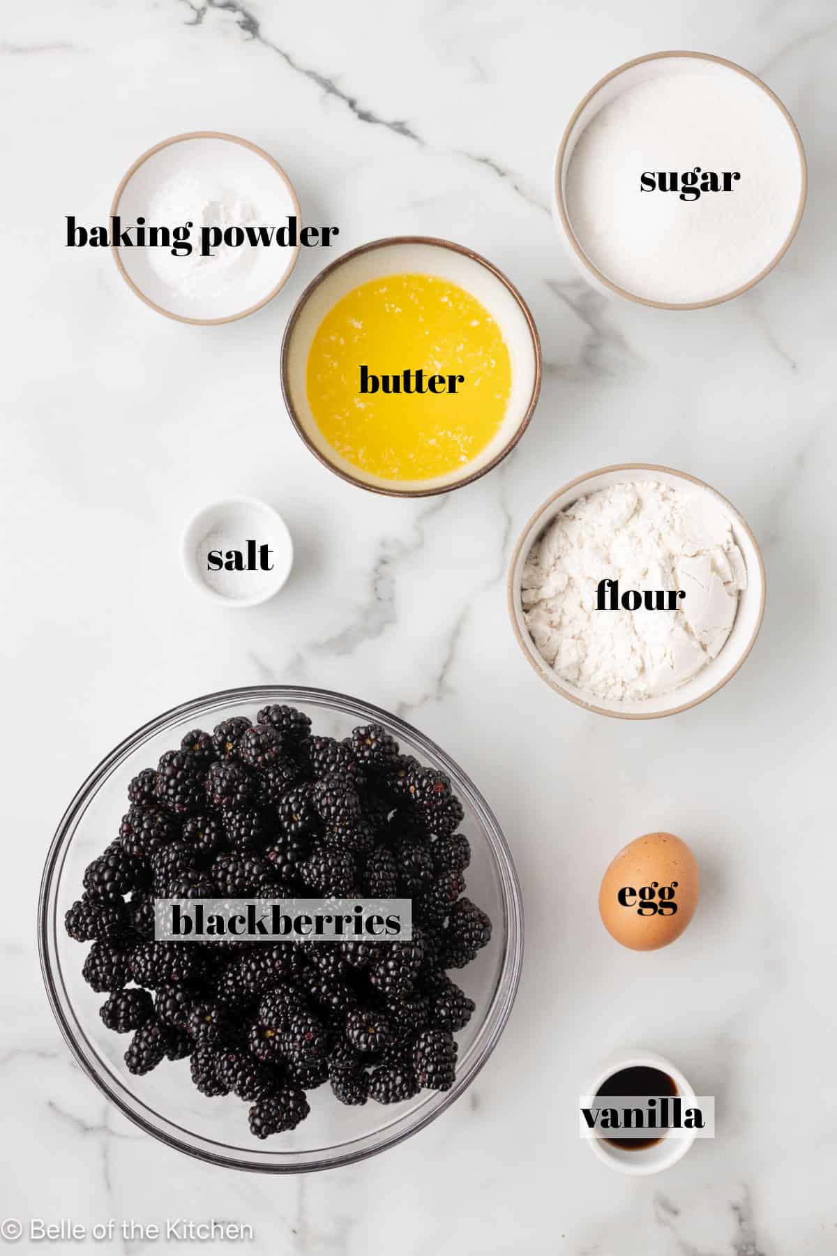 Bowls of ingredients on a marble counter top.