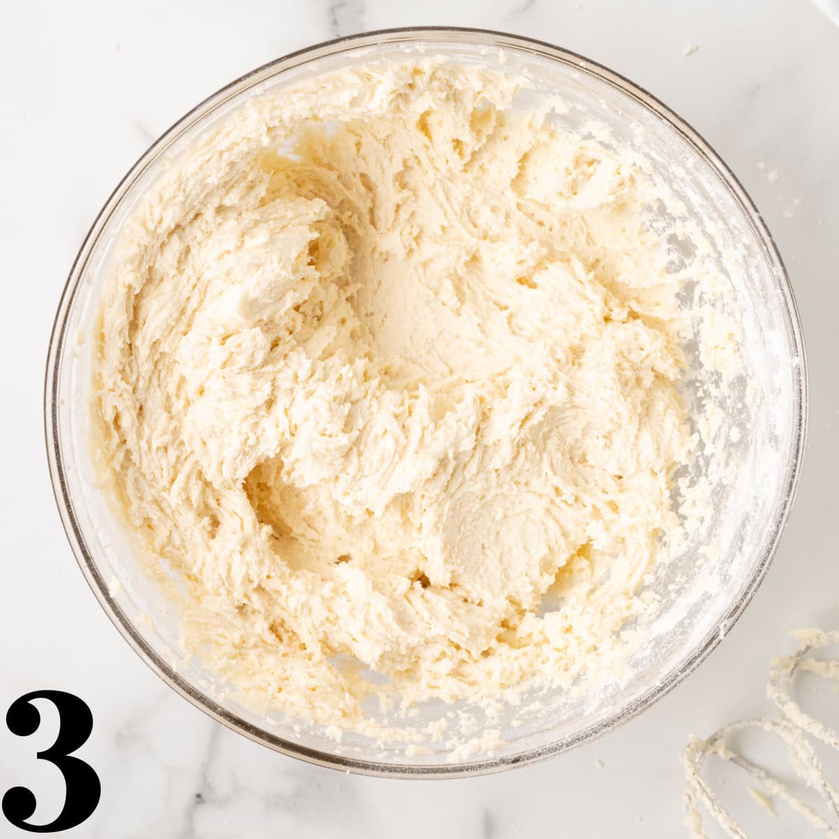 A glass bowl full of cobbler batter.