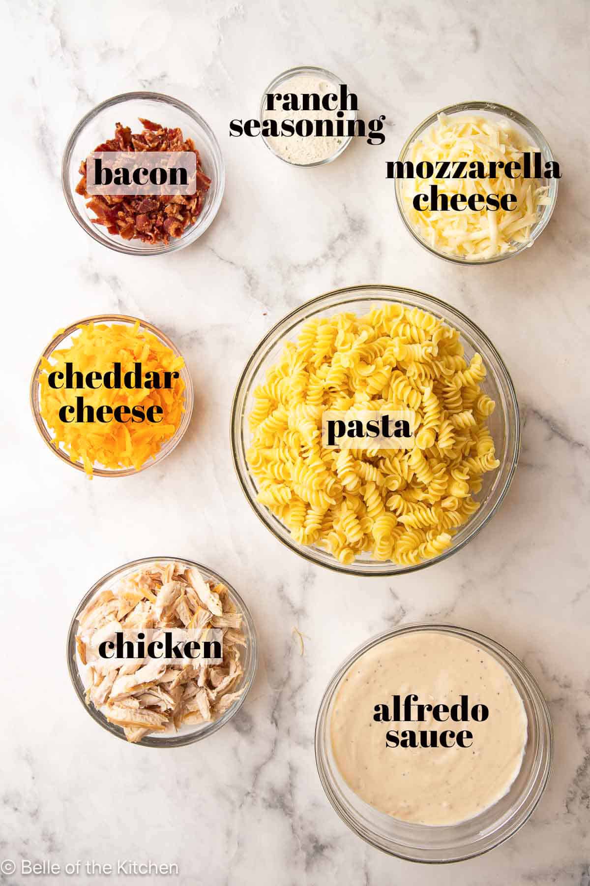 Bowls of ingredients on a marble counter top.