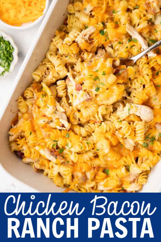 A white baking dish full of pasta, chicken, bacon, and cheese.