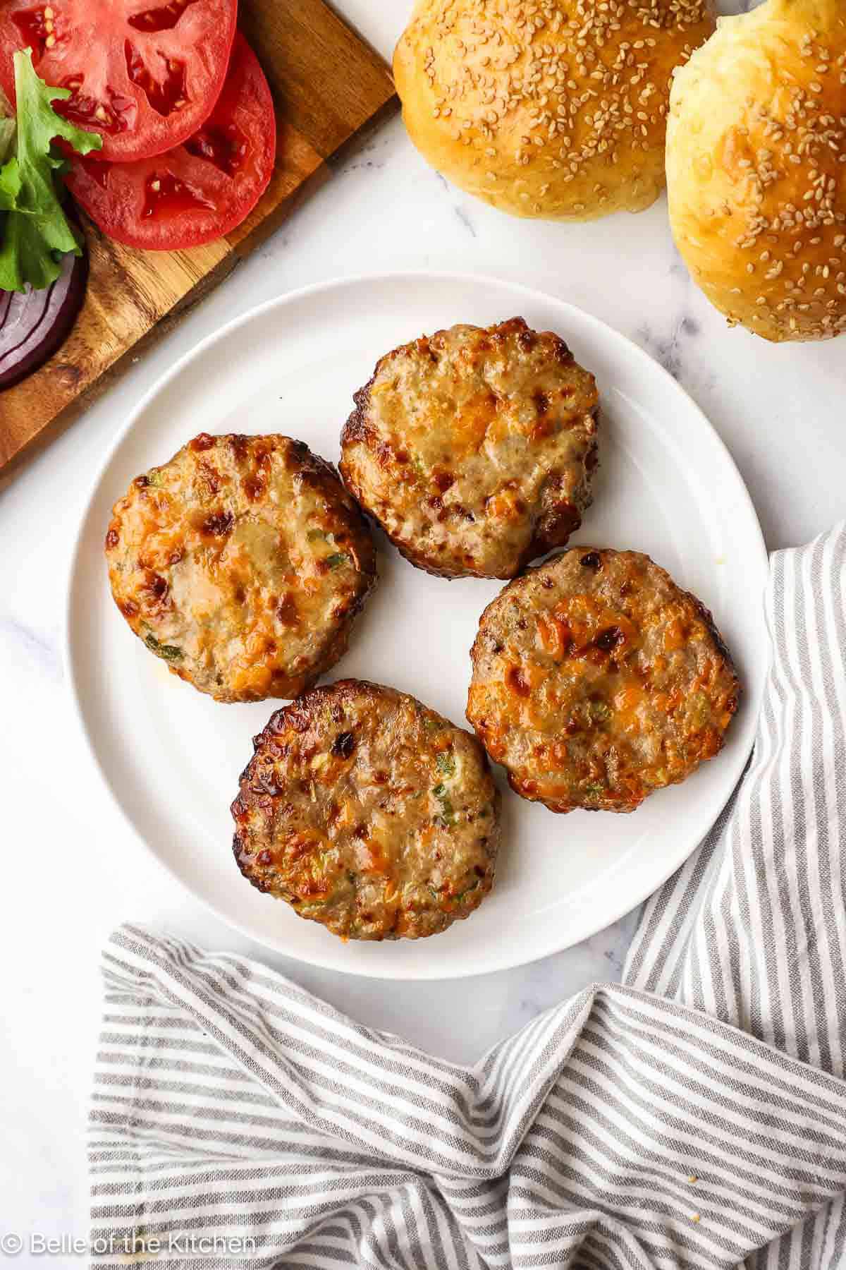 Turkey burger patties on a white plate.