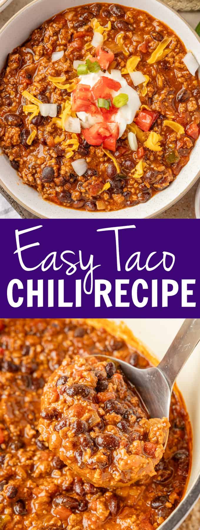 A white bowl of chili topped with sour cream, tomatoes, onions, and cheese.