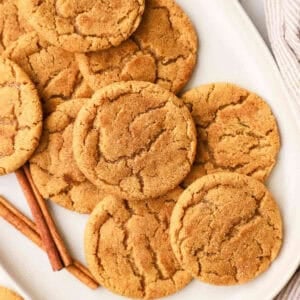A white platter full of pumpkin snickerdoodle cookies.