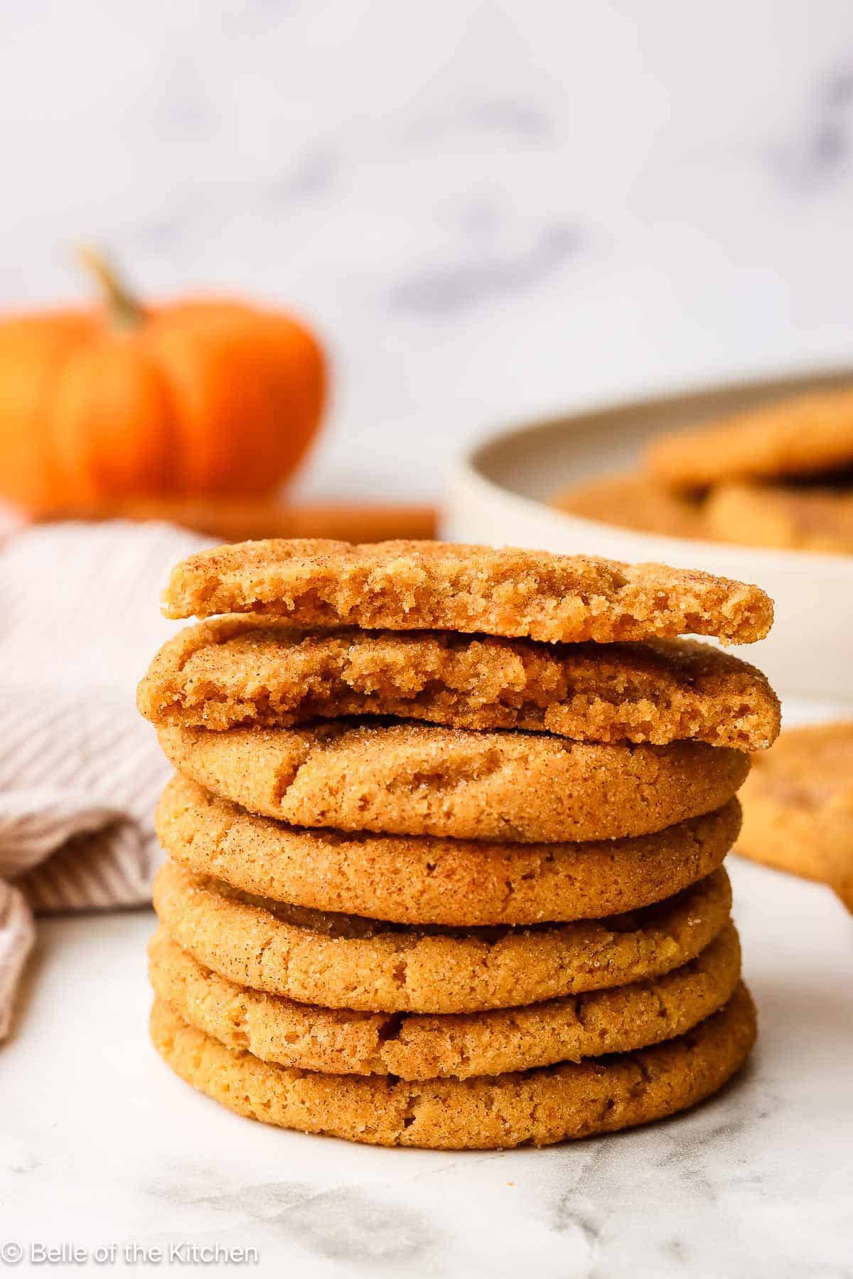 A stack of pumpkin snickerdoodle cookies on a counter top.