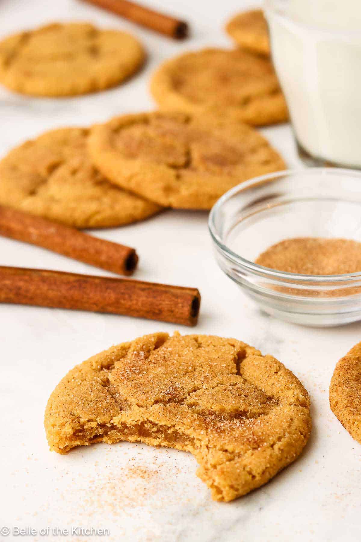 A pumpkin cookie with a bite taken out.