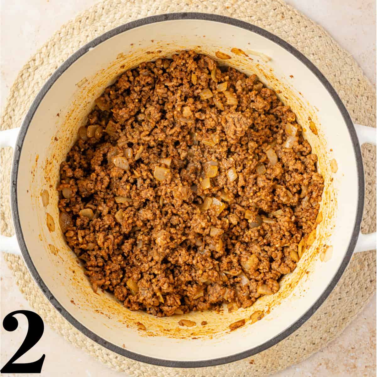 A dutch oven full of cooked taco meat.